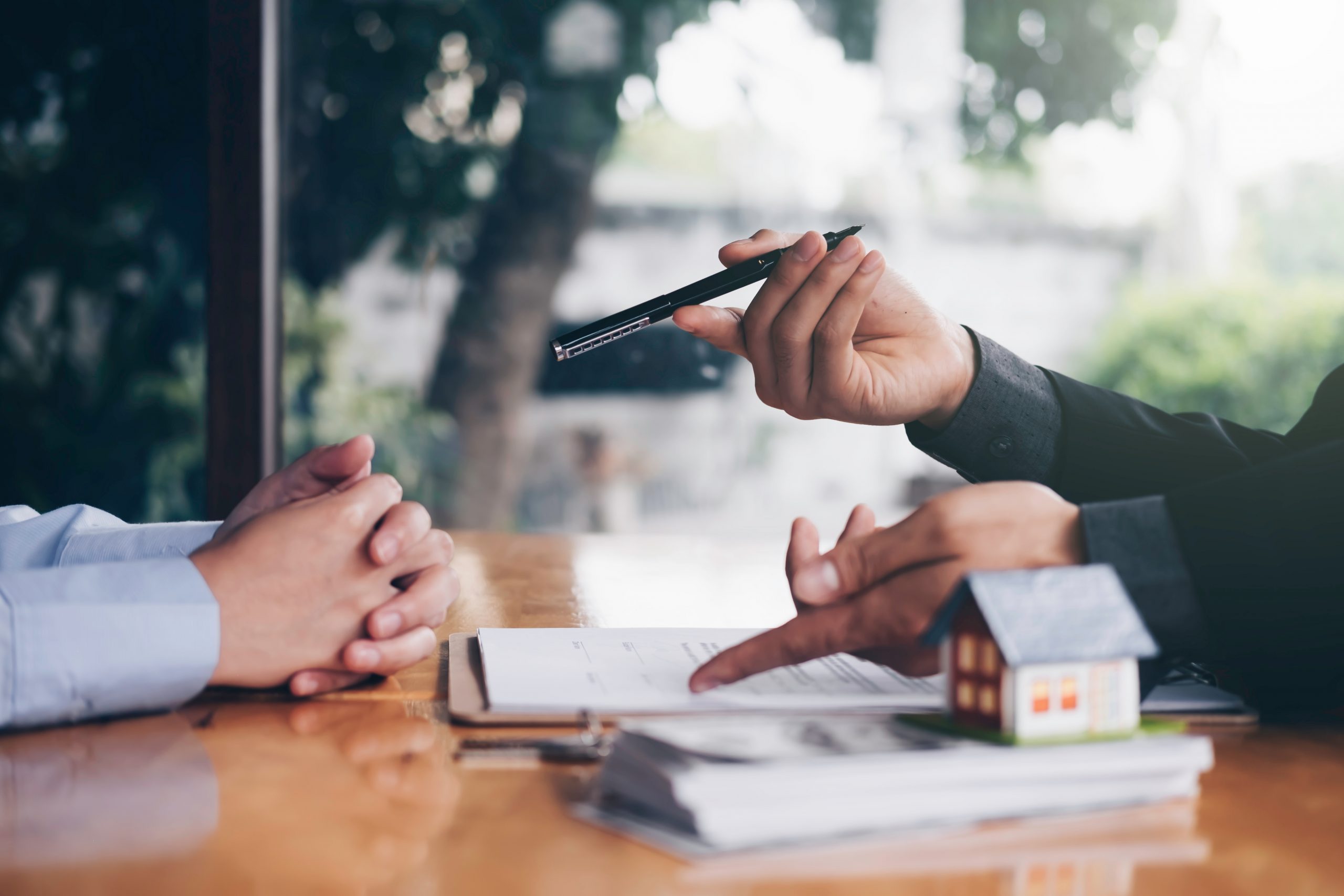 real estate agent holding house key to his client after signing contract,concept for real estate, moving home or renting property